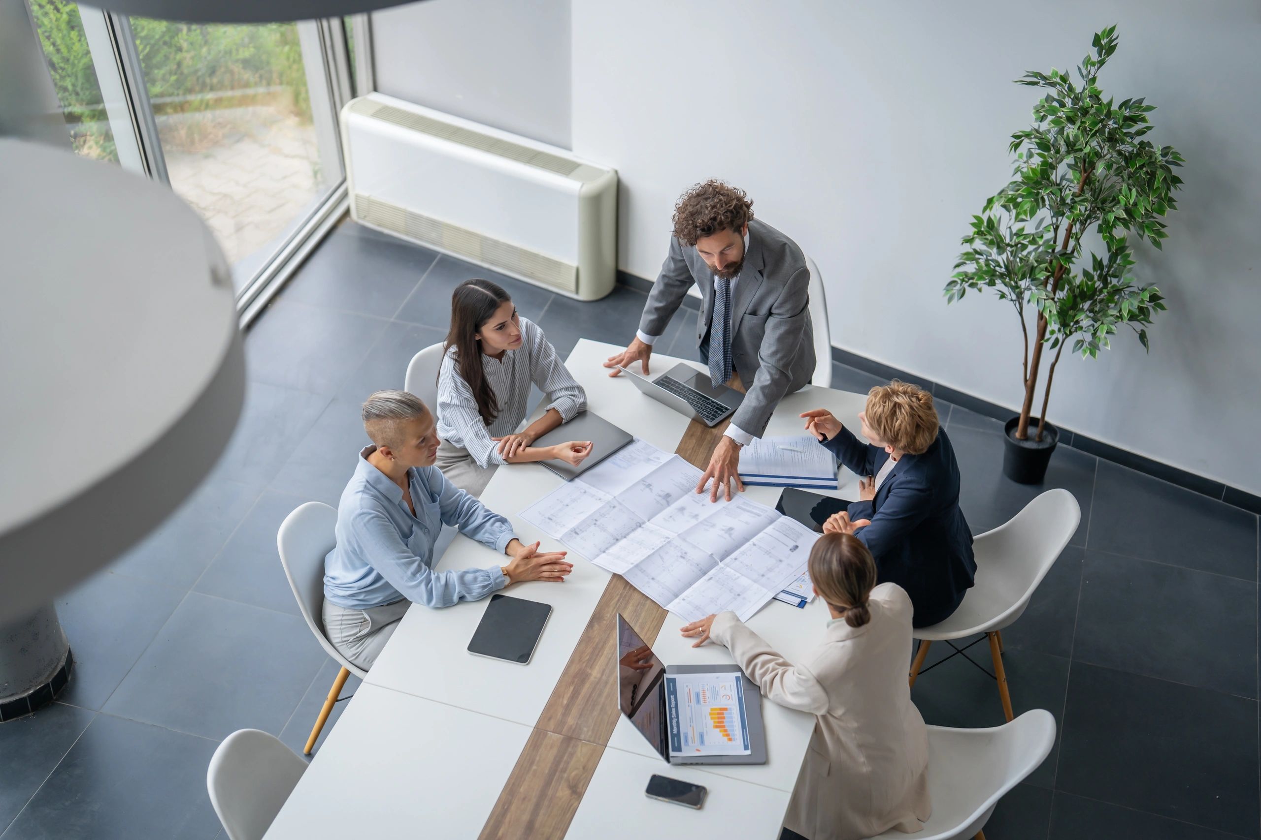 Team reviewing project plans in an office meeting